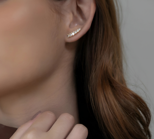 Close-up of a person wearing a brown top with a neutral background